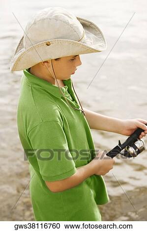 High angle view of a teenage boy fishing in a lake View Large Photo Image Stock Image - High angle view of a teenage boy fishing in a lake. Fotosearch