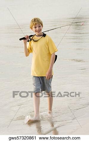 High angle view of a teenage boy walking in a lake with a fishing rod View Large Photo Image Stock Image - High angle view of a teenage boy walking in a lake with a fishing rod. Fotosearch