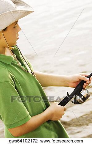 High angle view of a teenage boy fishing in a lake View Large Photo Image Stock Image - High angle view of a teenage boy fishing in a lake. Fotosearch