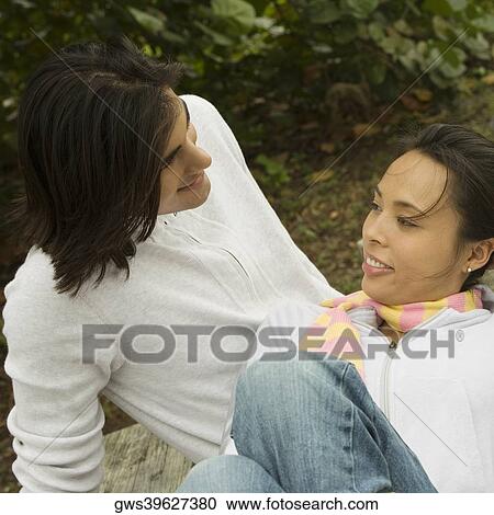 High angle view of a young couple looking at each other smiling View Large Photo Image Stock Image - High angle view of a young couple looking at each other smiling. Fotosearch