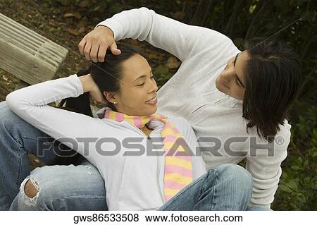 High angle view of a young couple looking at each other smiling View Large Photo Image Stock Photo - High angle view of a young couple looking at each other smiling. Fotosearch