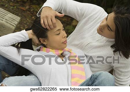 High angle view of a young couple looking at each other View Large Photo Image Stock Photography - High angle view of a young couple looking at each other. Fotosearch