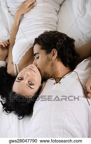 High angle view of a young man kissing a young woman View Large Photo Image Stock Image - High angle view of a young man kissing a young woman. Fotosearch