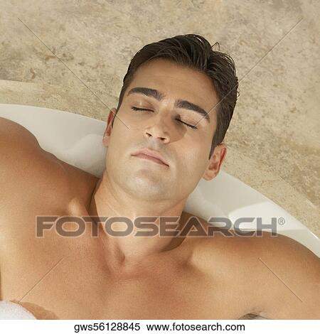 High angle view of a young man relaxing in the bathtub View Large Photo Image Stock Photography - High angle view of a young man relaxing in the bathtub. Fotosearch