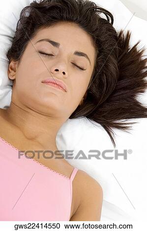 High angle view of a young woman sleeping on the bed View Large Photo Image Stock Image - High angle view of a young woman sleeping on the bed. Fotosearch