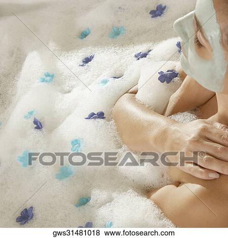 High angle view of a young woman wearing a facial mask in a bathtub View Large Photo Image Stock Photo - High angle view of a young woman wearing a facial mask in a bathtub. Fotosearch