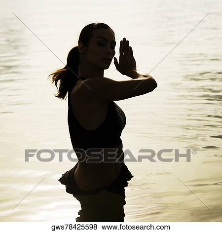 High angle view of a young woman exercising in a lake View Large Photo Image Stock Photo - High angle view of a young woman exercising in a lake. Fotosearch