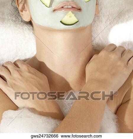 High angle view of a young woman wearing a facial mask in a bathtub View Large Photo Image Stock Photograph - High angle view of a young woman wearing a facial mask in a bathtub. Fotosearch