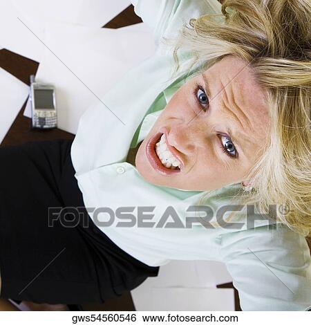High angle view of a young woman clenching her teeth View Large Photo Image Stock Photograph - High angle view of a young woman clenching her teeth. Fotosearch