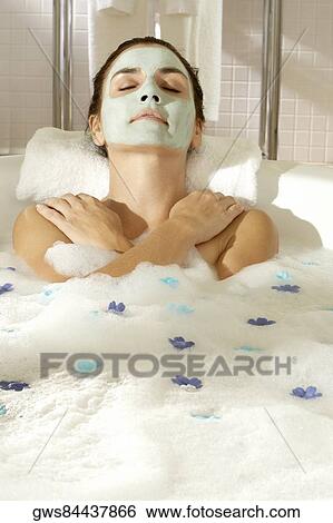 High angle view of a young woman wearing a facial mask in a bathtub View Large Photo Image Stock Photograph - High angle view of a young woman wearing a facial mask in a bathtub. Fotosearch