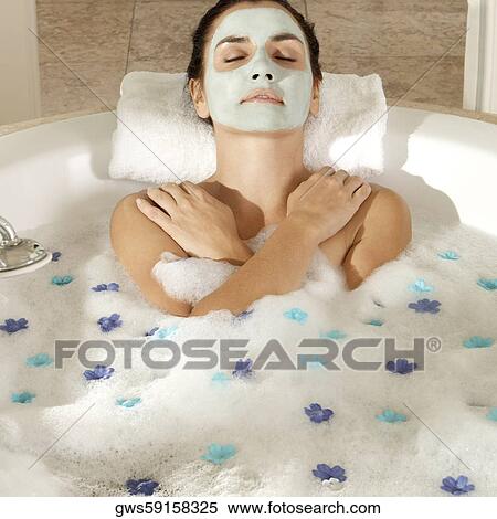 High angle view of a young woman wearing a facial mask in a bathtub View Large Photo Image Stock Photography - High angle view of a young woman wearing a facial mask in a bathtub. Fotosearch