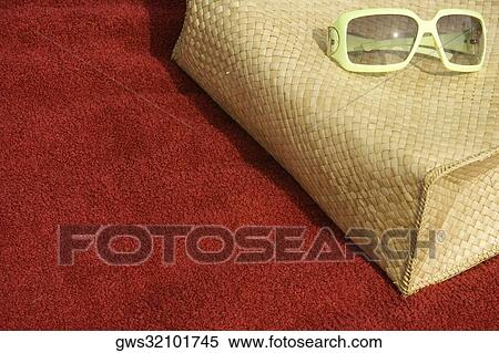 High angle view of sunglasses lying over a bag View Large Photo Image Stock Photography - High angle view of sunglasses lying over a bag. Fotosearch