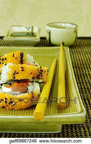 High angle view of sushi on a serving tray with a pair of chopsticks View Large Photo Image Stock Photo - High angle view of sushi on a serving tray with a pair of chopsticks. Fotosearch