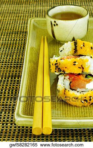 High angle view of sushi on a serving tray with a pair of chopsticks View Large Photo Image Stock Photography - High angle view of sushi on a serving tray with a pair of chopsticks. Fotosearch