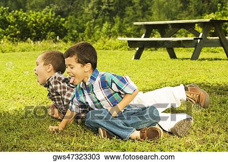 High angle view of two boys playing on the grass View Large Photo Image Stock Image - High angle view of two boys playing on the grass. Fotosearch