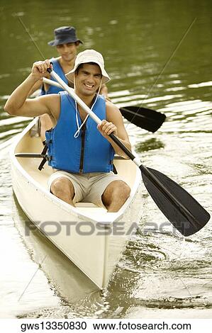 Stock Image - High angle view of two mid adult men boating in a river. Fotosearch