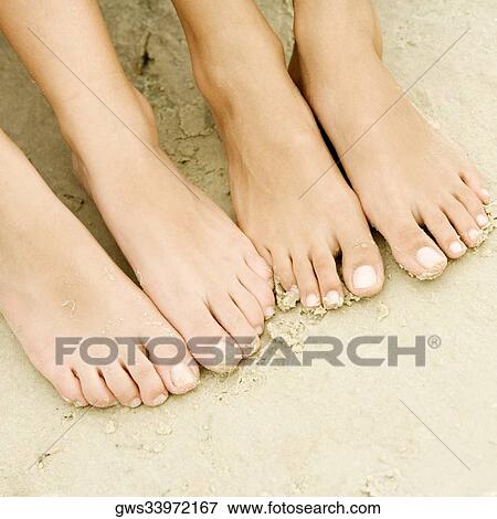 High angle view of two people bare feet View Large Photo Image Stock Photo - High angle view of two people bare feet. Fotosearch