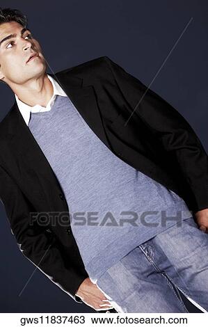 Stock Image - Low angle view of a mid adult man standing. Fotosearch