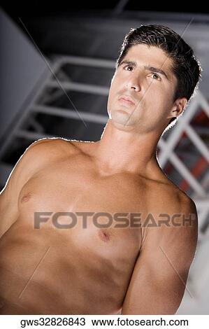 Low angle view of a mid adult man looking away View Large Photo Image Stock Image - Low angle view of a mid adult man looking away. Fotosearch