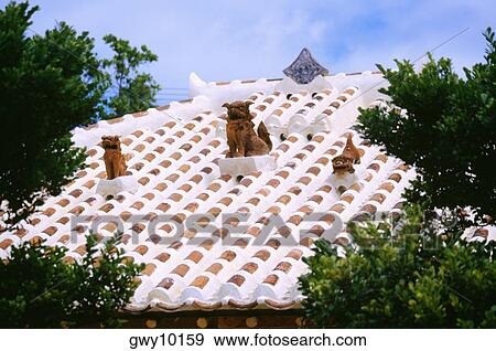 Stock Photo - Low angle view of animal figures on a roof, Ryukyu Islands, Japan. Fotosearch