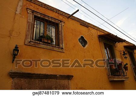 Stock Photo - Low angle view of potted plants on a balcony, Mexico. Fotosearch