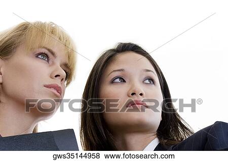 Low angle view of two businesswomen looking away View Large Photo Image Stock Photo - Low angle view of two businesswomen looking away. Fotosearch