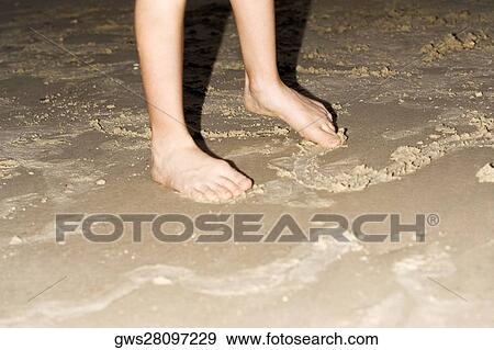 Low section view of a person standing on mud View Large Photo Image Stock Photo - Low section view of a person standing on mud. Fotosearch