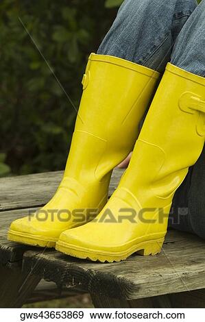 Low section view of a person wearing rubber boots View Large Photo Image Stock Photo - Low section view of a person wearing rubber boots. Fotosearch