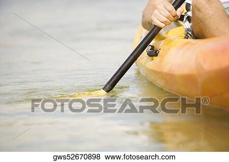Man on a kayak in a lake View Large Photo Image Stock Photo - Man on a kayak in a lake. Fotosearch