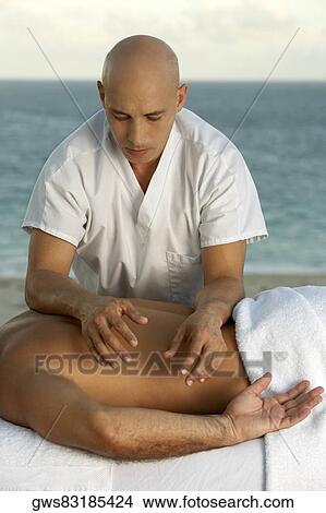 Mature man giving a man a back massage View Large Photo Image Picture - Mature man giving a man a back massage. Fotosearch