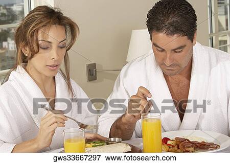 Mid adult couple having breakfast View Large Photo Image Stock Photo - Mid adult couple having breakfast. Fotosearch