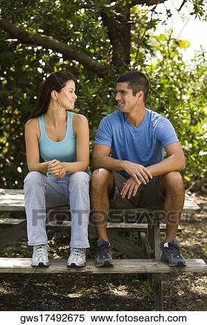 Mid adult man and a young woman looking at each other View Large Photo Image Stock Photography - Mid adult man and a young woman looking at each other. Fotosearch