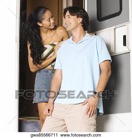 Mid adult man and a young woman smiling View Large Photo Image Stock Image - Mid adult man and a young woman smiling. Fotosearch