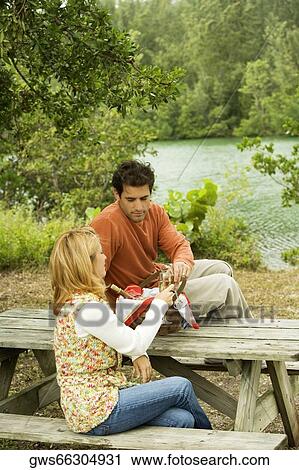 Mid adult man and a young woman toasting with wineglasses View Large Photo Image Stock Image - Mid adult man and a young woman toasting with wineglasses. Fotosearch