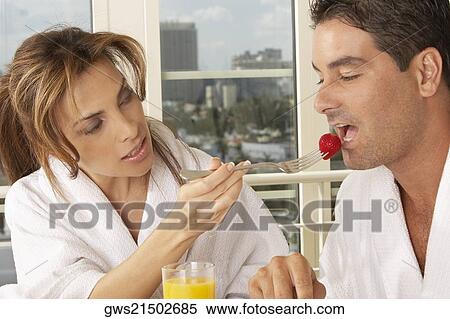 Mid adult woman feeding a mid adult man a strawberry View Large Photo Image Stock Photography - Mid adult woman feeding a mid adult man a strawberry. Fotosearch