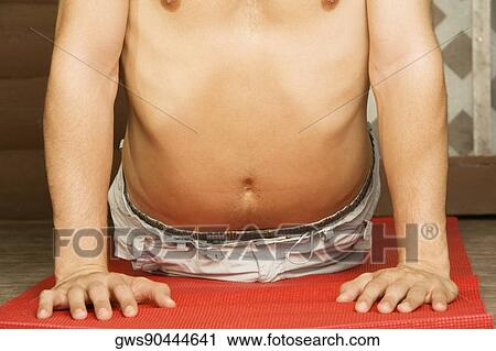 Mid section view of a bare chested young man performing the cobra pose View Large Photo Image Stock Image - Mid section view of a bare chested young man performing the cobra pose. Fotosearch