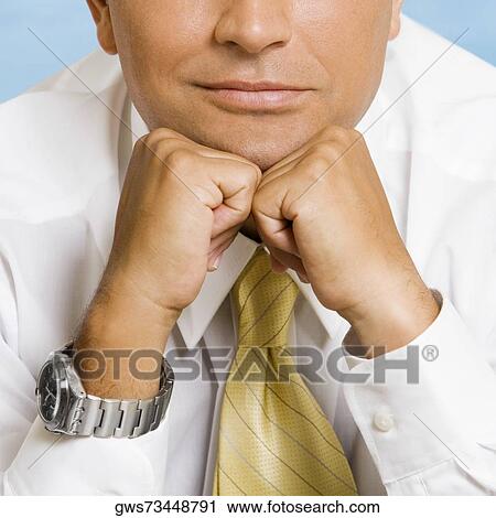 Mid section view of a businessman thinking with his hands under his chin View Large Photo Image Stock Image - Mid section view of a businessman thinking with his hands under his chin. Fotosearch