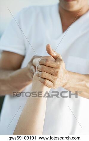 Mid section view of a massage therapist giving foot massage to a woman View Large Photo Image Stock Image - Mid section view of a massage therapist giving foot massage to a woman. Fotosearch