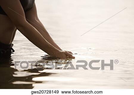 Mid section view of a woman in a lake View Large Photo Image Stock Photo - Mid section view of a woman in a lake. Fotosearch
