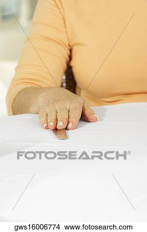Mid section view of a woman with her hand on a table knife View Large Photo Image Picture - Mid section view of a woman with her hand on a table knife. Fotosearch