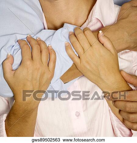 Stock Image - Mid section view of two people embracing. Fotosearch