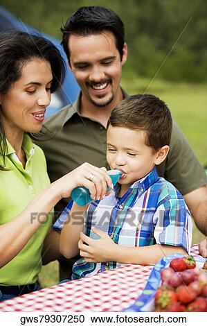 Mother feeding her son with a bottle View Large Photo Image Stock Image - Mother feeding her son with a bottle. Fotosearch