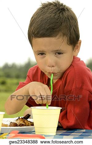 Portrait of a boy drinking with a straw View Large Photo Image Stock Photo - Portrait of a boy drinking with a straw. Fotosearch