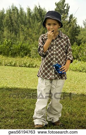Portrait of a boy eating a chocolate View Large Photo Image Stock Image - Portrait of a boy eating a chocolate. Fotosearch