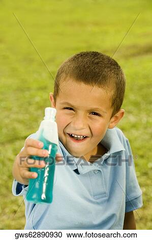 Portrait of a boy holding a bottle View Large Photo Image Stock Image - Portrait of a boy holding a bottle. Fotosearch