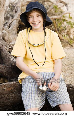 Stock Photo - Portrait of a boy holding a fishing rod. Fotosearch