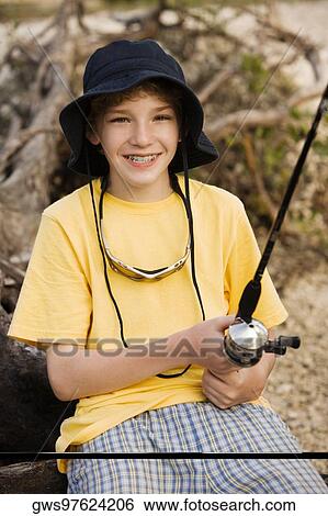 Portrait of a boy holding a fishing rod View Large Photo Image Stock Photograph - Portrait of a boy holding a fishing rod. Fotosearch