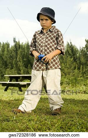 Portrait of a boy holding a packet of chocolates View Large Photo Image Stock Photograph - Portrait of a boy holding a packet of chocolates. Fotosearch