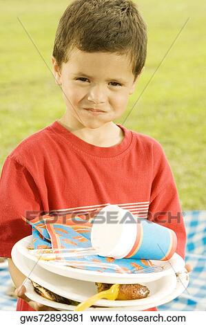 Portrait of a boy holding plates View Large Photo Image Stock Image - Portrait of a boy holding plates. Fotosearch