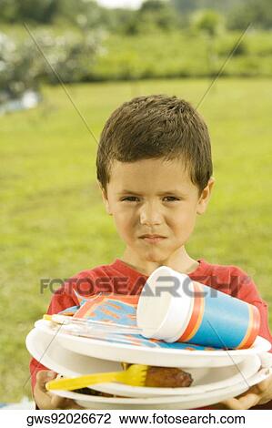 Portrait of a boy holding plates View Large Photo Image Stock Image - Portrait of a boy holding plates. Fotosearch